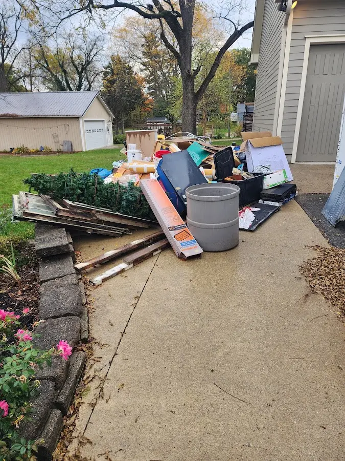 Dumpster being loaded with debris for 30 Yard Dumpster Rental in Laureles